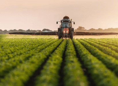 A tractor and a sprayer working on a field